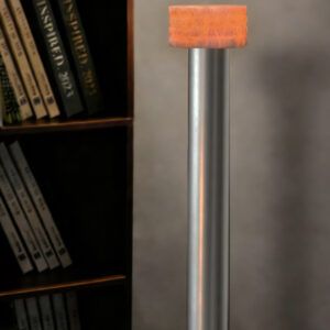 Close-up of a silver metal pole with an orange fabric-wrapped cap, beside a dark bookshelf.