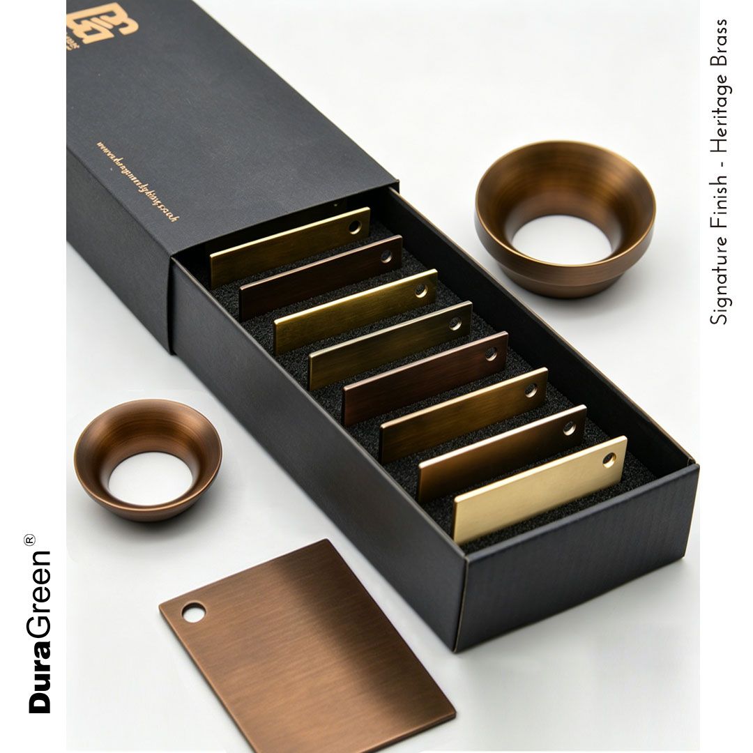 Box of DuraGreen Heritage Brass finish swatches in gold-to-bronze tones with holes in the swatches.