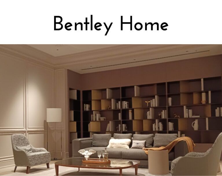 Luxurious Bentley Home showroom living room with beige walls, dark shelving, and gray seating.