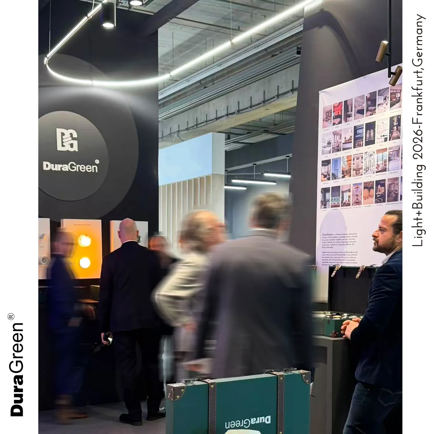 DuraGreen booth at a trade show with a large circular logo wall, display panels of images on the right, and blurred visitors walking by; a teal DuraGreen case in the foreground.