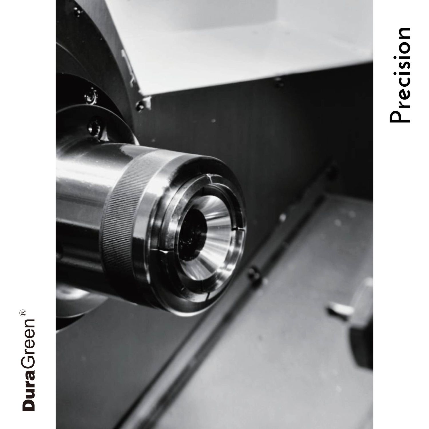Close-up of a metal lathe chuck clamping a cylindrical workpiece in black and white.