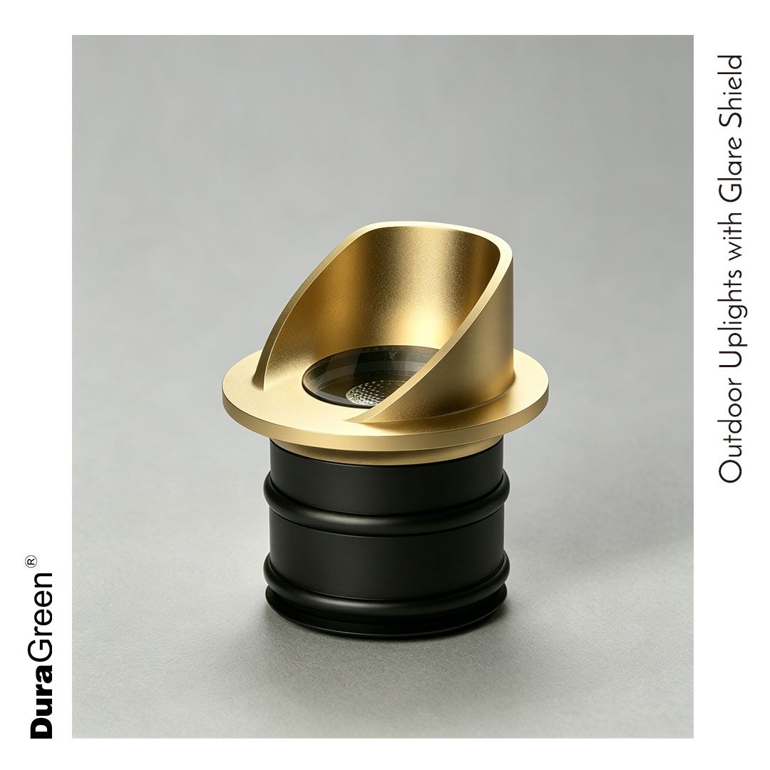 Gold outdoor uplight with a glare shield atop a black base, designed for landscape lighting.