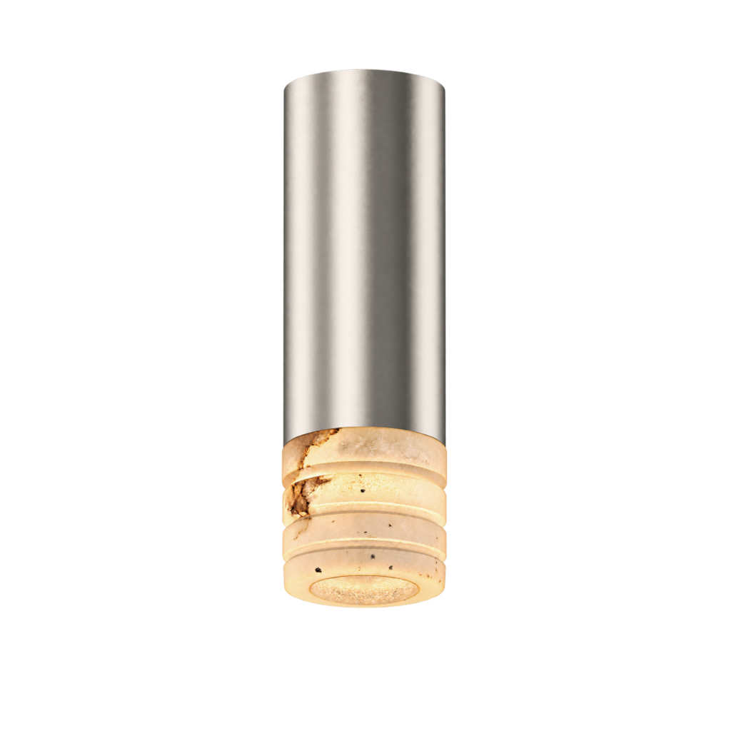 Tall stainless steel cylinder against a black background with a stack of bagels at the bottom edge.