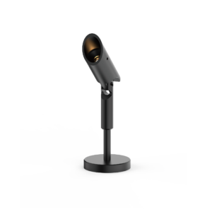 Close-up of a black studio microphone mounted on a stand with a circular base and a rounded head.